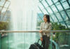 Things to Do on a Layover in Singapore for Cabin Crew: Crew-Friendly Ideas by Time and Energy Flight attendant near Jewel Changi Waterfall in Singapore with skyline view