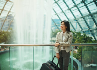 Things to Do on a Layover in Singapore for Cabin Crew: Crew-Friendly Ideas by Time and Energy Flight attendant near Jewel Changi Waterfall in Singapore with skyline view